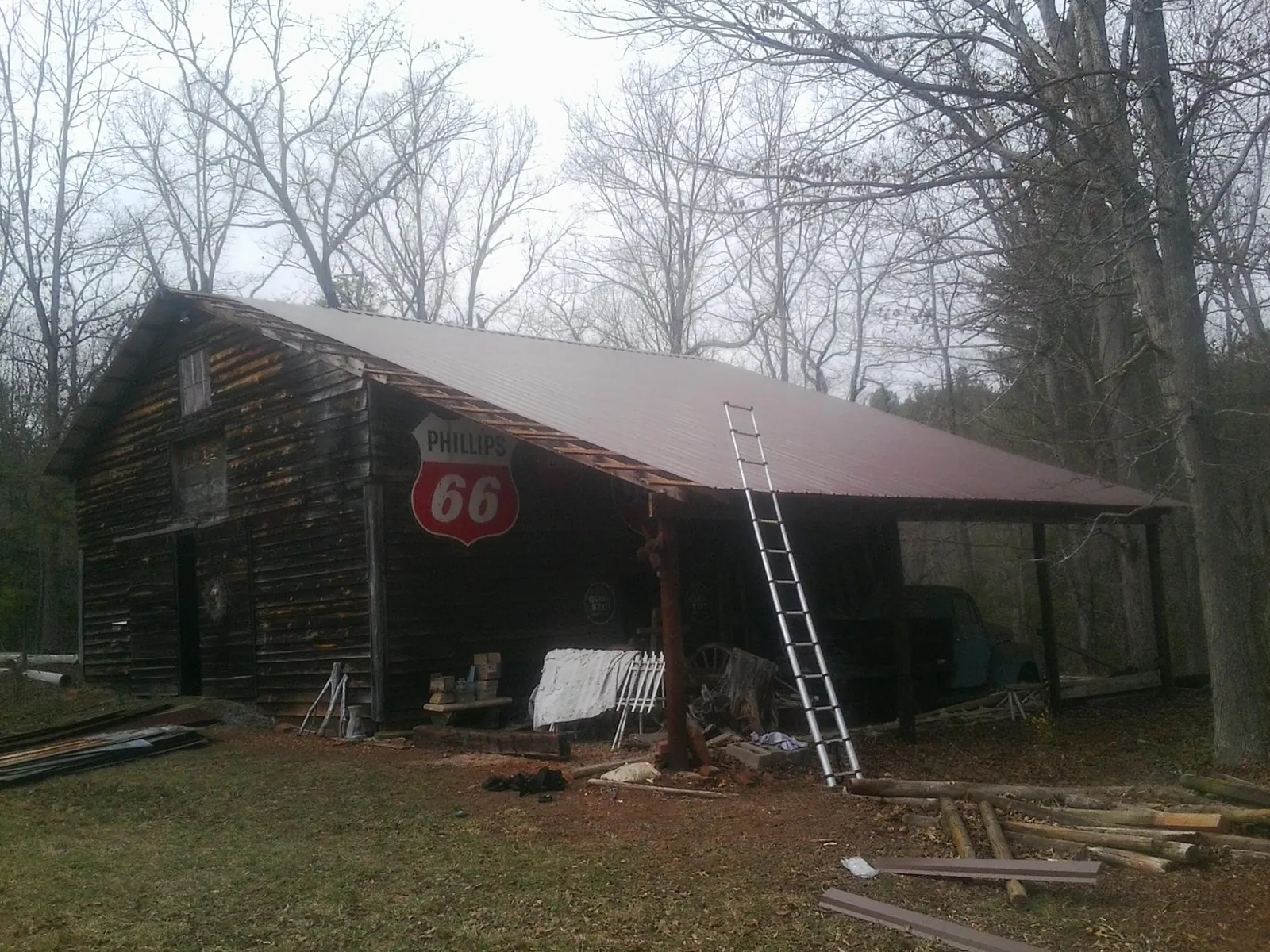 New metal roof on an open sided timber barn with a vintage sign in Grand River